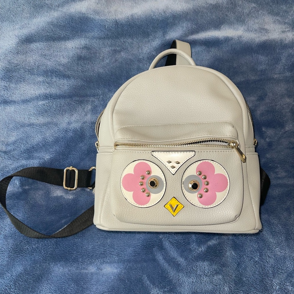 grey mini backpack with an owl on the front